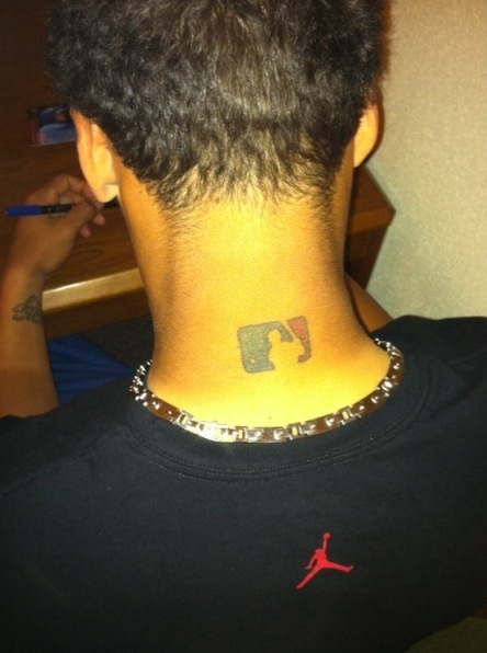 FILE - Then-Chicago Cubs' Javier Baez sports an MLB logo tattoo